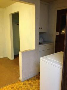 Bonus room from kitchen with washer, dryer and door to backyard